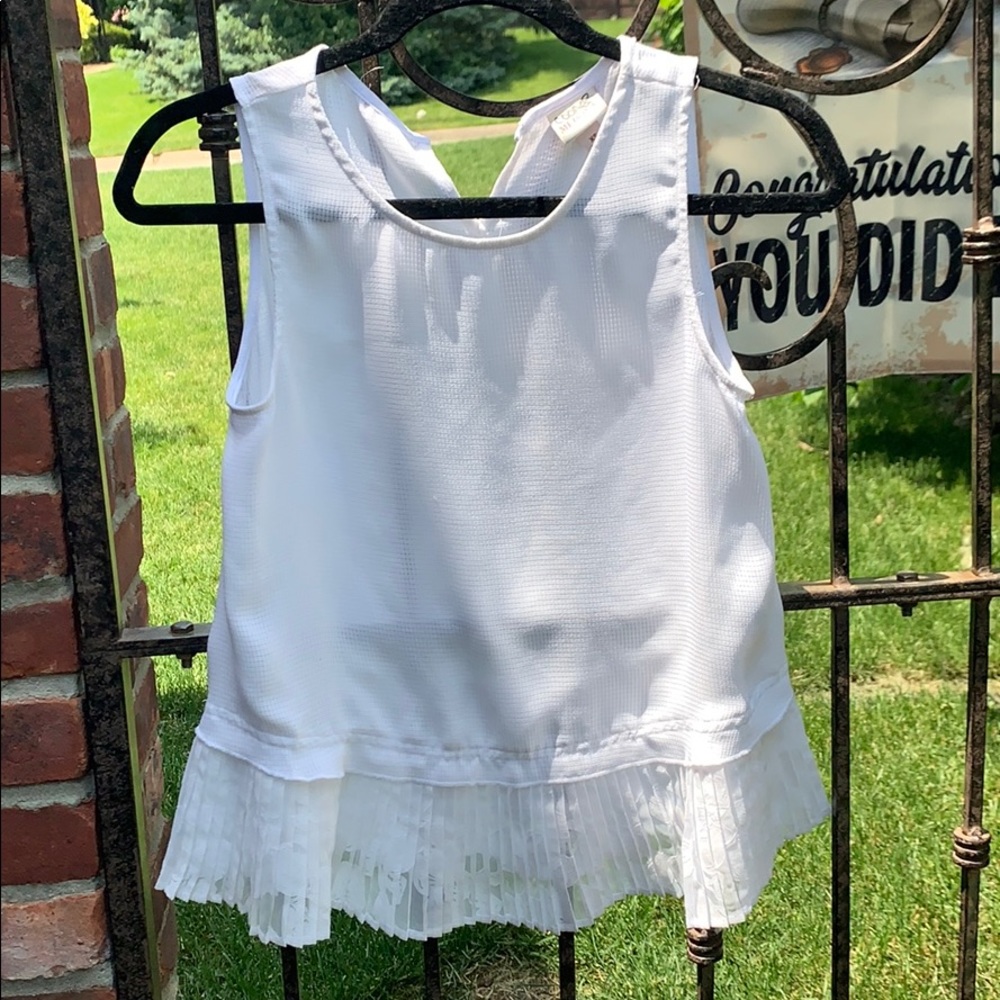 White peplum sleeveless blouse
